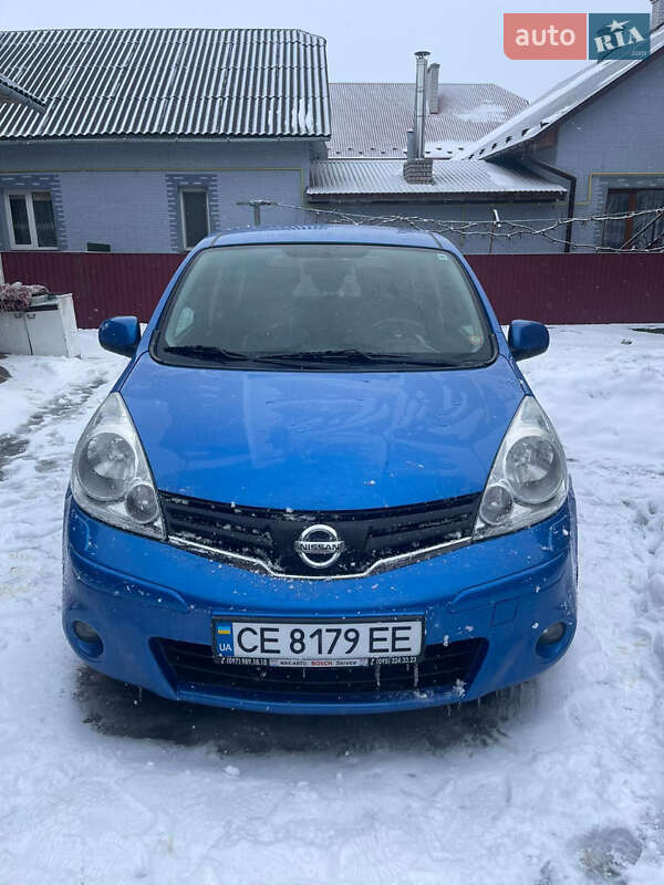 2011 Nissan Note, VIN SJNFDAE11U2121199:plate — фото 1 (autoria)